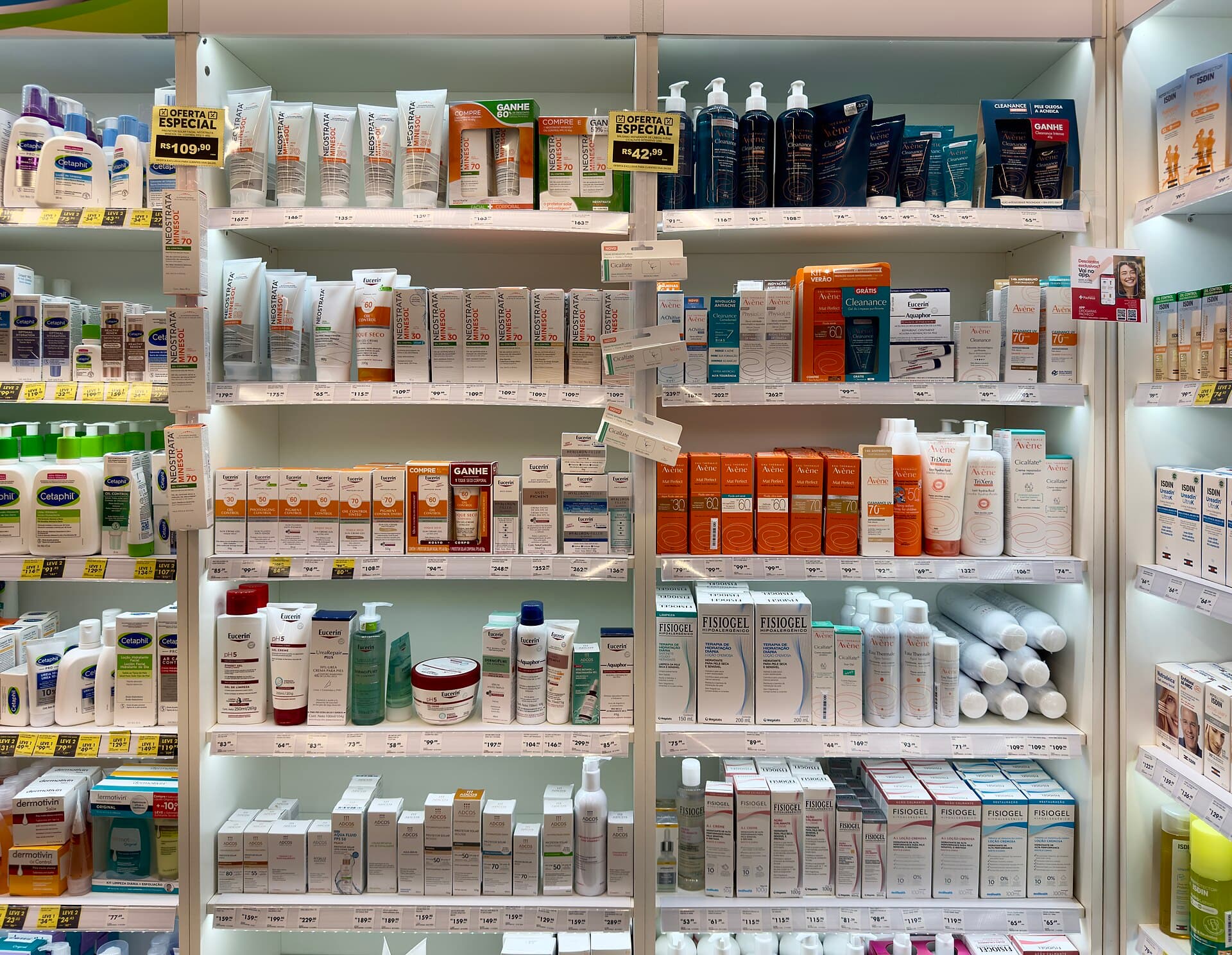 Skin care cosmetics arranged across shelves in a bright drugstore aisle.